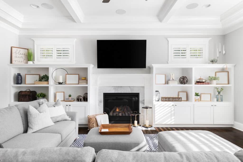 Image of a living room with built-in shelving, a fireplace, television, and decorations.
Living Room, Shelf, Television Set, Fireplace, Modern, Home